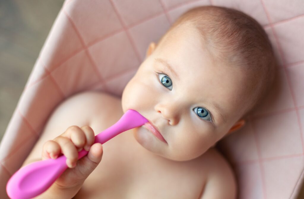 Baby chewing on a teething toy to soothe sore gums.